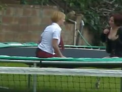 Two naughty girls jump on trampoline