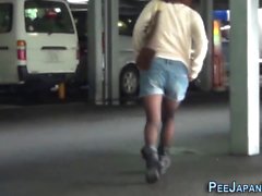 Asian urinates in street